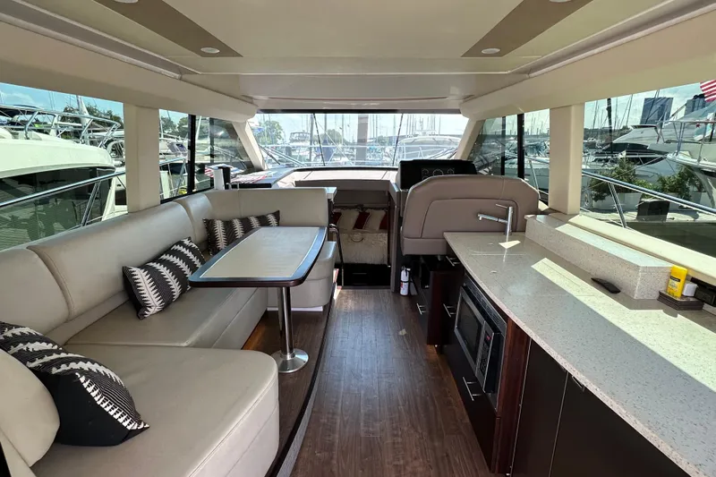 Yacht Photos Pics Luxurious interior of 2019 Regal 42 Fly yacht with modern seating and kitchen area.