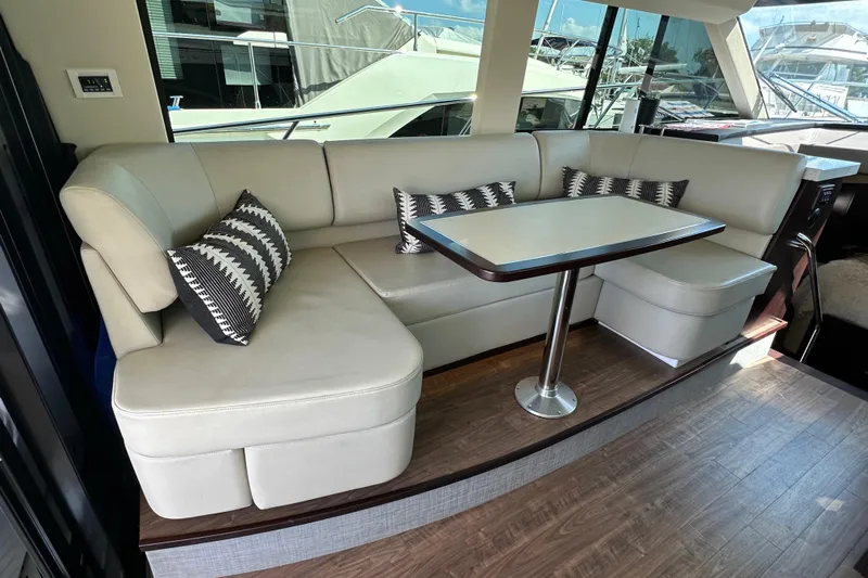  Yacht Photos Pics Luxurious interior of 2019 Regal 42 Fly yacht with elegant seating and table.