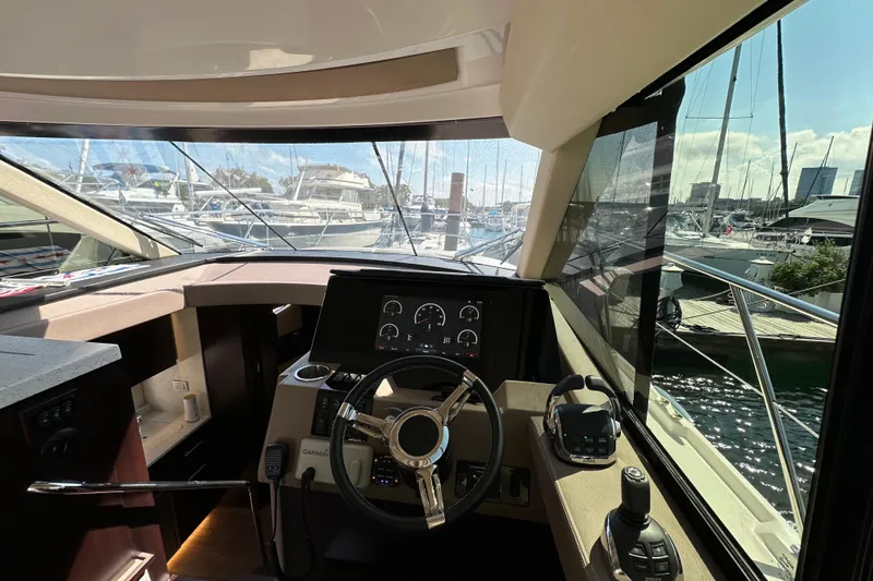  Yacht Photos Pics Interior view of 2019 Regal 42 Fly yacht cockpit with steering wheel and navigation controls.