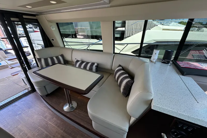  Yacht Photos Pics Luxurious interior of 2019 Regal 42 Fly yacht with elegant seating and table.