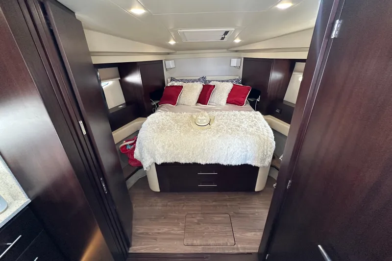  Yacht Photos Pics Luxurious cabin interior of 2019 Regal 42 Fly yacht with cozy bed and elegant decor.