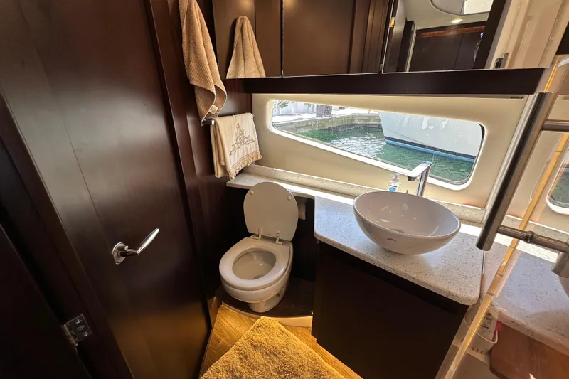  Yacht Photos Pics Luxurious bathroom interior of 2019 Regal 42 Fly yacht with modern fixtures and window view.