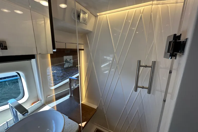  Yacht Photos Pics Luxurious bathroom interior of 2019 Regal 42 Fly yacht with modern fixtures and window view.