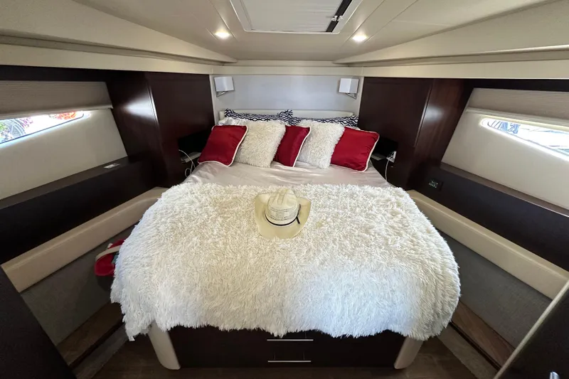 Yacht Photos Pics Luxurious cabin interior of 2019 Regal 42 Fly yacht with plush bedding and decor.