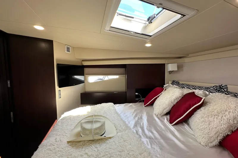  Yacht Photos Pics Luxurious cabin interior of 2019 Regal 42 Fly yacht with skylight and plush bedding.