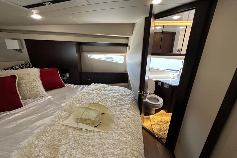  Yacht Photos Pics Luxurious 2019 Regal 42 Fly yacht bedroom with ensuite bathroom and cozy decor.