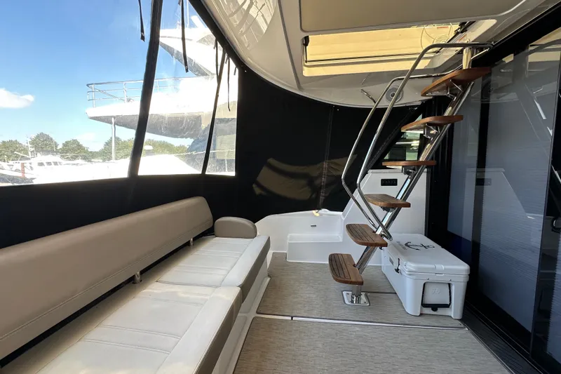  Yacht Photos Pics Interior of 2019 Regal 42 Fly yacht with seating and wooden staircase.