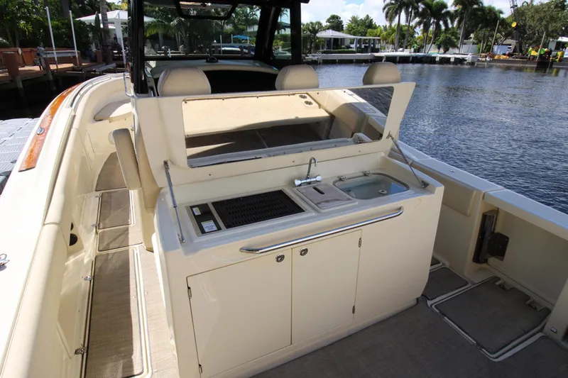 Lilaia Yacht Photos Pics 2020 Chris-Craft Catalina 34 boat interior with kitchenette and sink by the water.