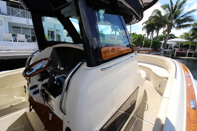 Lilaia Yacht Photos Pics 2020 Chris-Craft Catalina 34 boat interior with wooden accents and steering wheel.