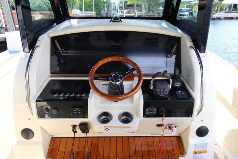 Lilaia Yacht Photos Pics 2020 Chris-Craft Catalina 34 helm with wooden steering wheel and modern controls.