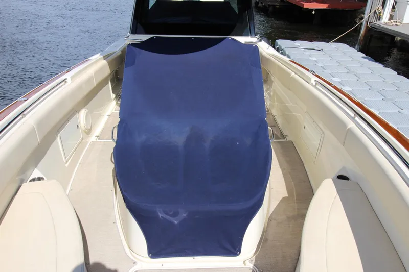 Lilaia Yacht Photos Pics 2020 Chris-Craft Catalina 34 boat interior with blue cover, docked by the water.