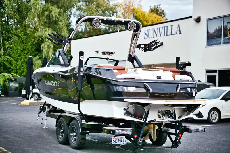  Yacht Photos Pics 2022 MasterCraft X24 boat on trailer outside Sunvilla dealership.