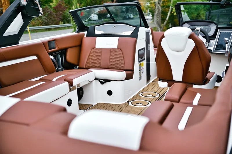  Yacht Photos Pics Luxurious interior of 2022 MasterCraft X24 boat with brown and white seating.