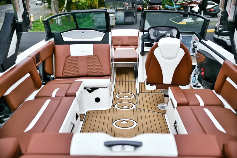  Yacht Photos Pics 2022 MasterCraft X24 boat interior with luxurious brown and white seating and modern dashboard.