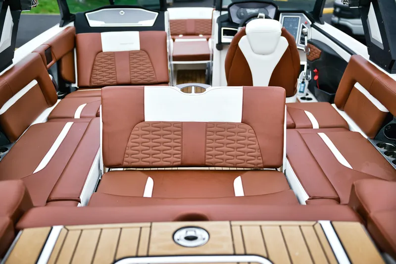  Yacht Photos Pics 2022 MasterCraft X24 boat interior with luxurious brown and white seating.