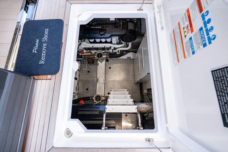 Next Play Yacht Photos Pics Engine room of 2024 Azimut Fly 68 yacht with visible machinery and safety instructions.