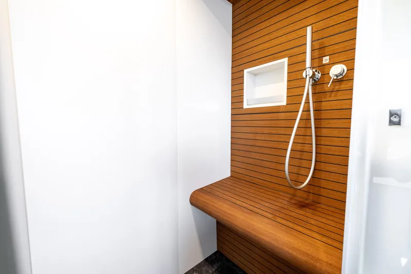 Next Play Yacht Photos Pics Luxurious shower area in 2024 Azimut Fly 68 yacht with wooden accents.