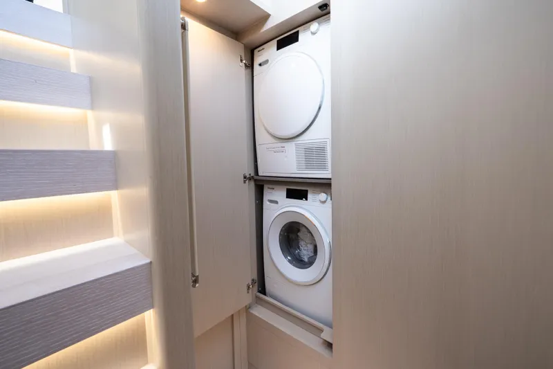 Next Play Yacht Photos Pics Laundry area with stacked washer and dryer in 2024 Azimut Fly 68 yacht.