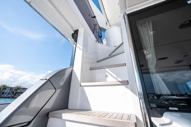 Next Play Yacht Photos Pics Staircase on 2024 Azimut Fly 68 yacht with modern design and ocean view.