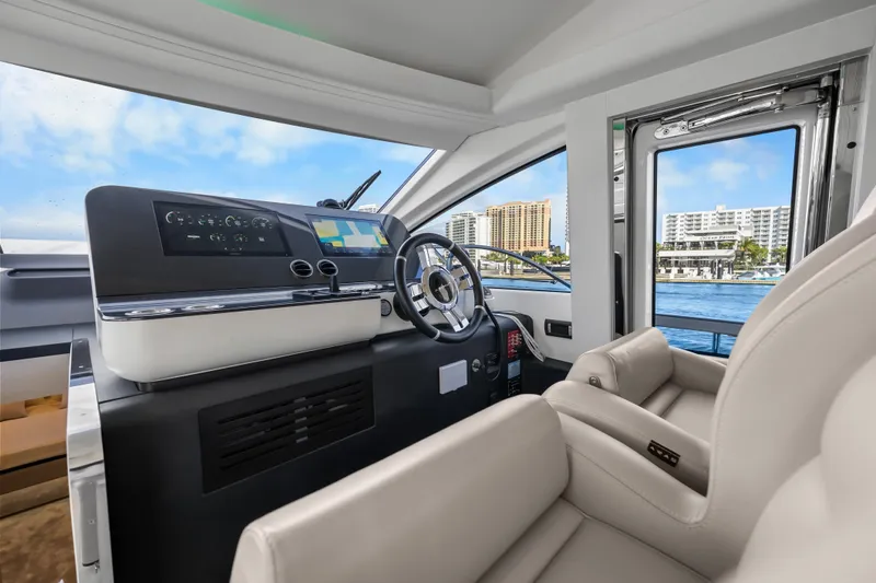 Next Play Yacht Photos Pics 2024 Azimut Fly 68 yacht helm with modern controls and waterfront view.