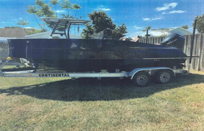  Yacht Photos Pics 2024 D-Boat 22 Diamond Series on trailer, parked on grass under blue sky.
