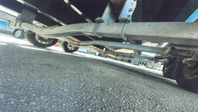  Yacht Photos Pics Underside view of 2024 D-Boat 22 Diamond Series trailer on pavement.