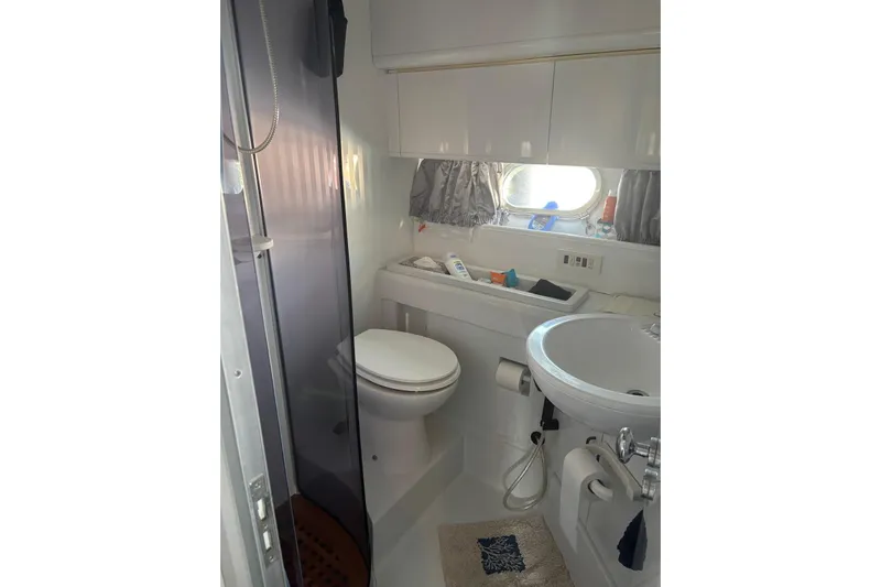  Yacht Photos Pics Bathroom interior of 1992 Mochi Craft 46 yacht, featuring toilet, sink, and shower.