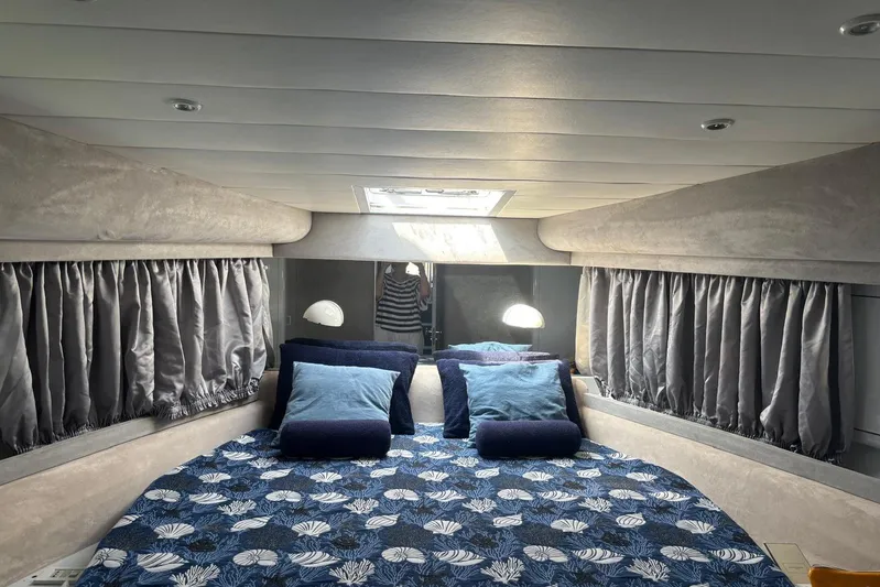  Yacht Photos Pics Luxurious cabin interior of 1992 Mochi Craft 46 yacht with cozy bedding and elegant curtains.