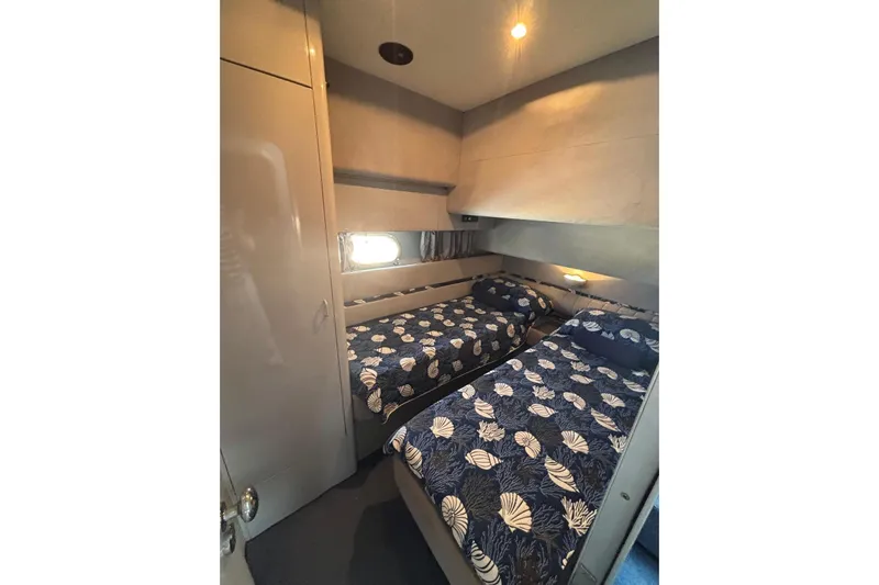  Yacht Photos Pics Twin cabin with nautical-themed bedding in 1992 Mochi Craft 46 yacht.