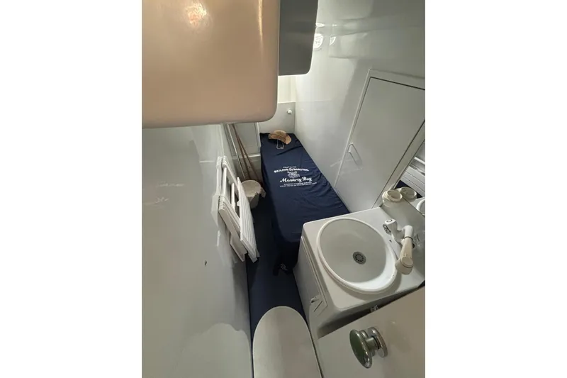  Yacht Photos Pics 1992 Mochi Craft 46 yacht interior with bed and compact bathroom sink.
