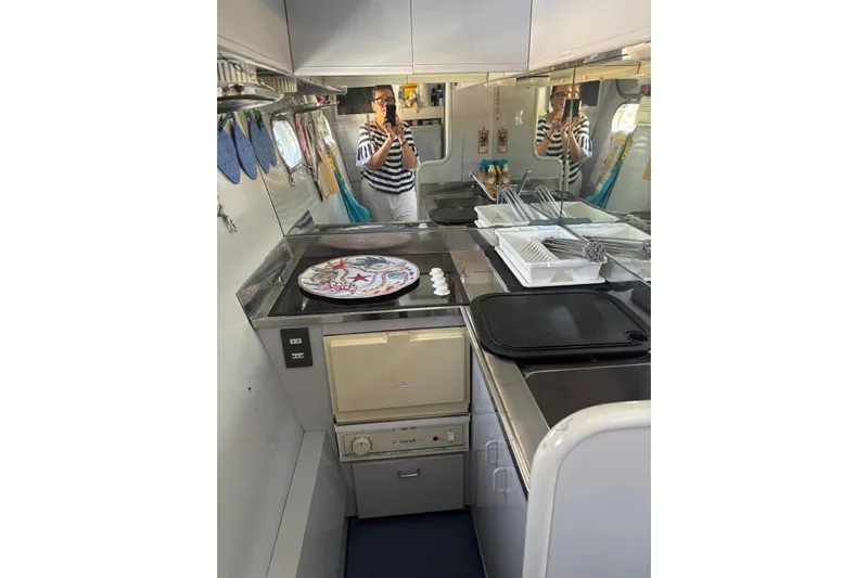  Yacht Photos Pics Compact kitchen in a 1992 Mochi Craft 46 yacht, featuring modern appliances and sleek design.