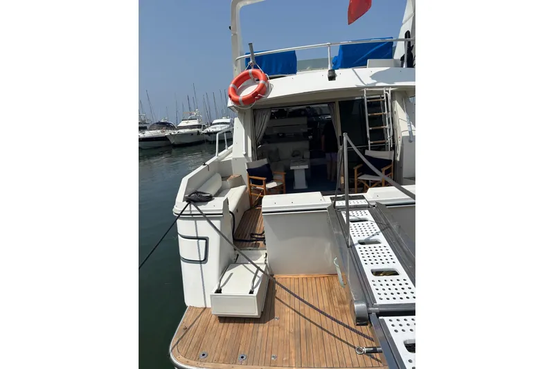  Yacht Photos Pics 1992 Mochi Craft 46 yacht docked, featuring a spacious deck and marina view.