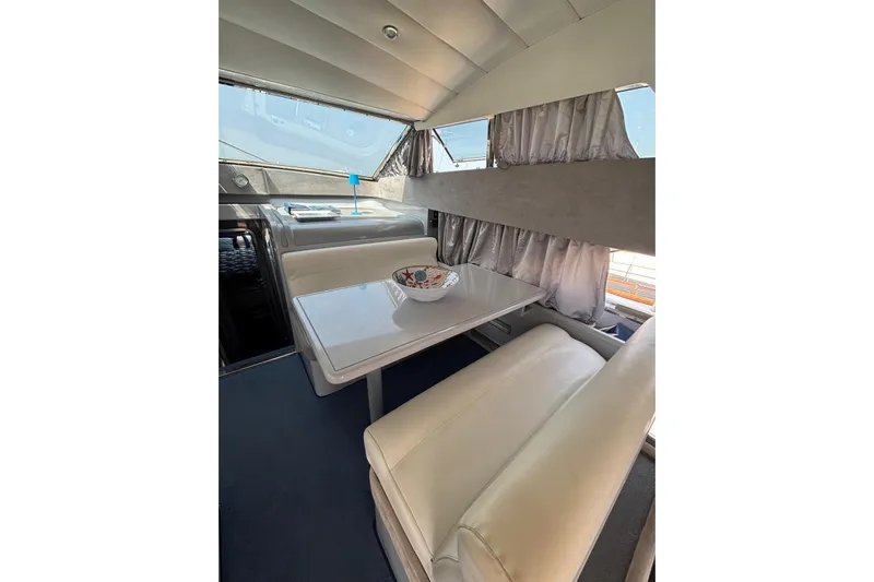  Yacht Photos Pics Interior of 1992 Mochi Craft 46 yacht with dining area and seating.