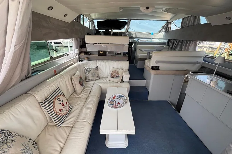  Yacht Photos Pics Luxurious interior of a 1992 Mochi Craft 46 yacht with elegant white seating.