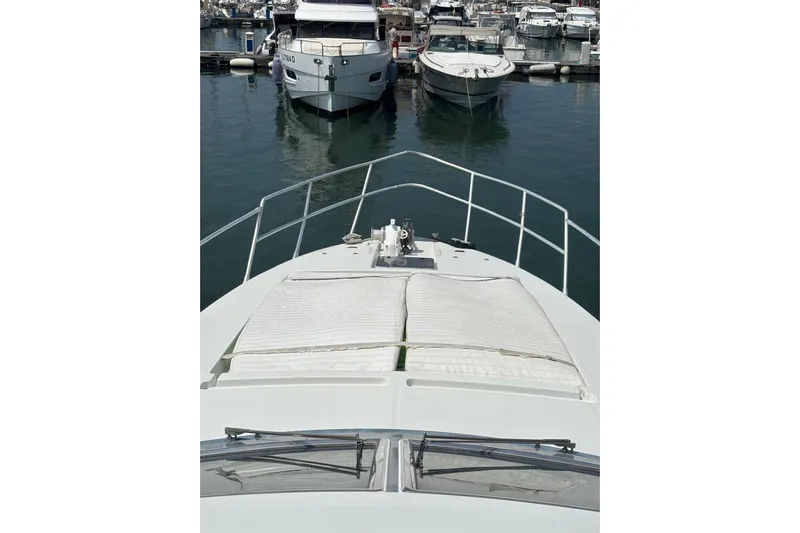  Yacht Photos Pics Bow view of 1992 Mochi Craft 46 yacht docked in a marina.