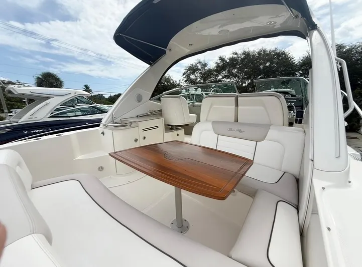  Yacht Photos Pics 2011 Sea Ray 350 Sundancer boat interior with seating and wooden table.