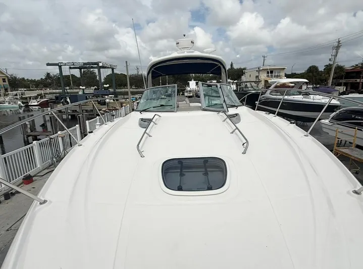  Yacht Photos Pics 2011 Sea Ray 350 Sundancer yacht docked at marina under cloudy sky.