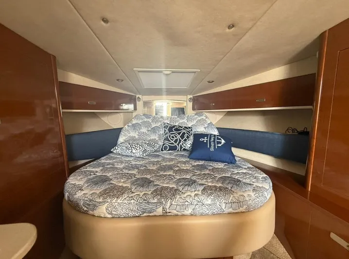  Yacht Photos Pics 2011 Sea Ray 350 Sundancer cabin with cozy bed and wooden storage cabinets.
