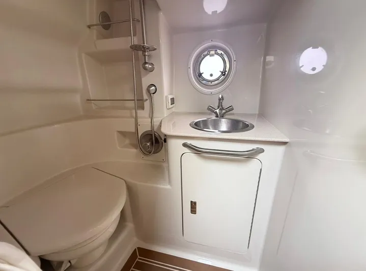  Yacht Photos Pics 2011 Sea Ray 350 Sundancer bathroom with sink, toilet, and porthole window.