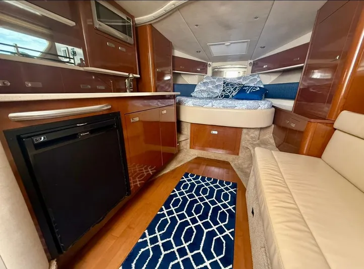  Yacht Photos Pics Luxurious interior of 2011 Sea Ray 350 Sundancer yacht with modern amenities and cozy sleeping area.