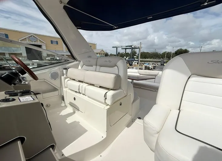  Yacht Photos Pics 2011 Sea Ray 350 Sundancer boat interior with white seating and steering area.