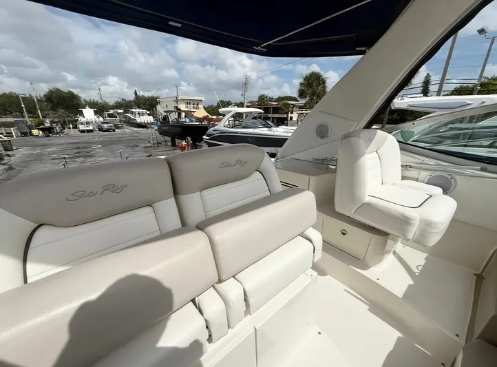  Yacht Photos Pics 2011 Sea Ray 350 Sundancer interior with plush seating and helm, docked at marina.