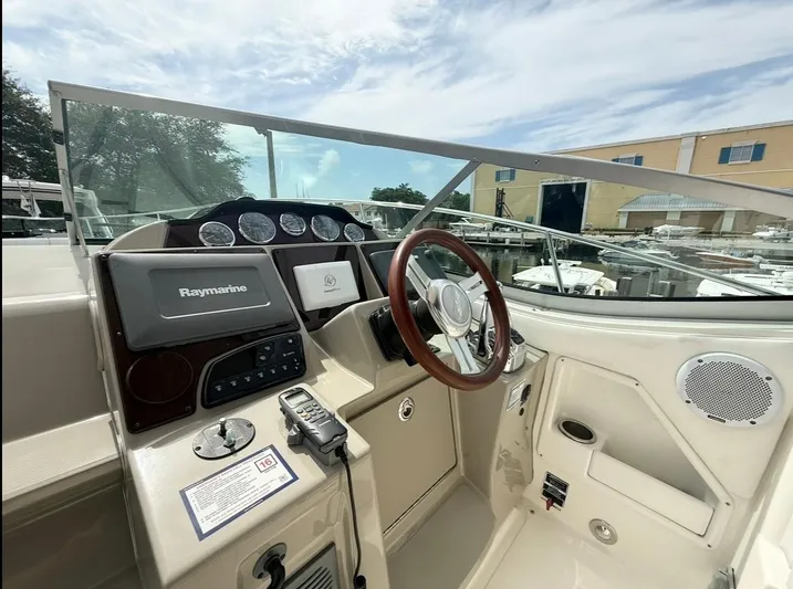  Yacht Photos Pics 2011 Sea Ray 350 Sundancer helm with Raymarine electronics and wooden steering wheel.