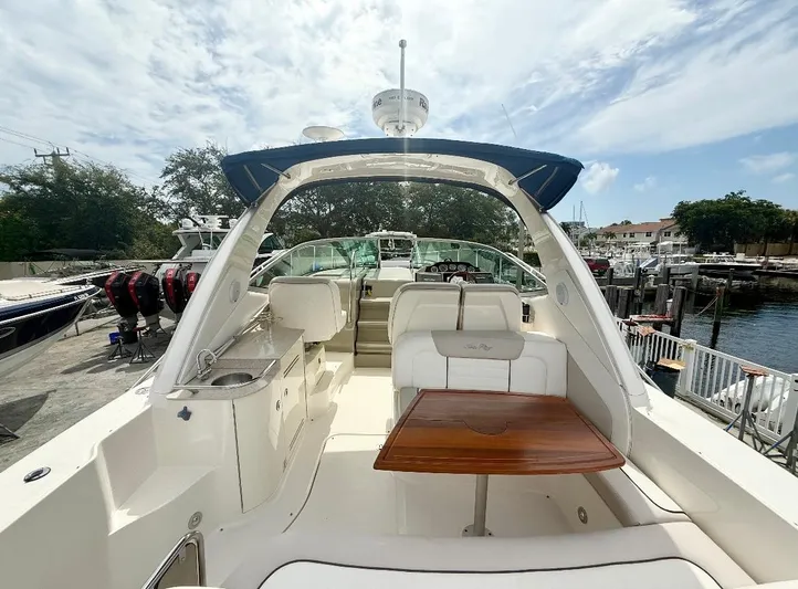  Yacht Photos Pics 2011 Sea Ray 350 Sundancer yacht interior with seating and table, docked at marina.
