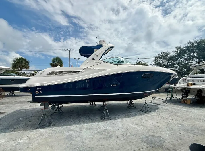  Yacht Photos Pics 2011 Sea Ray 350 Sundancer boat on stands under a partly cloudy sky.