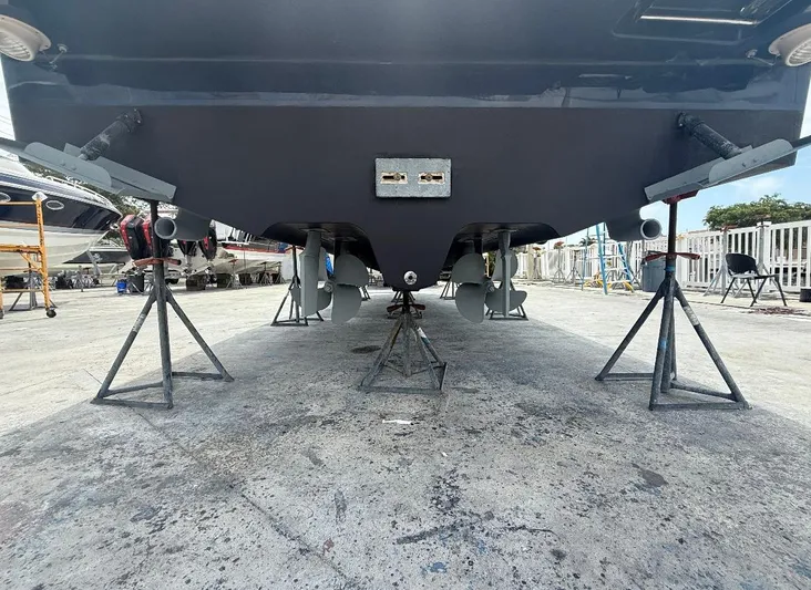  Yacht Photos Pics 2011 Sea Ray 350 Sundancer on stands, showing propellers and hull in a boatyard.