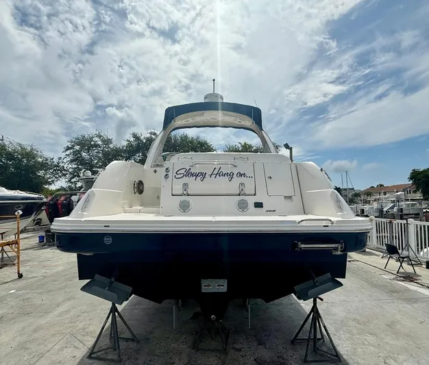  Yacht Photos Pics 2011 Sea Ray 350 Sundancer boat on dry dock under a partly cloudy sky.