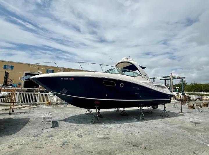  Yacht Photos Pics 2011 Sea Ray 350 Sundancer yacht on dry dock under cloudy sky.