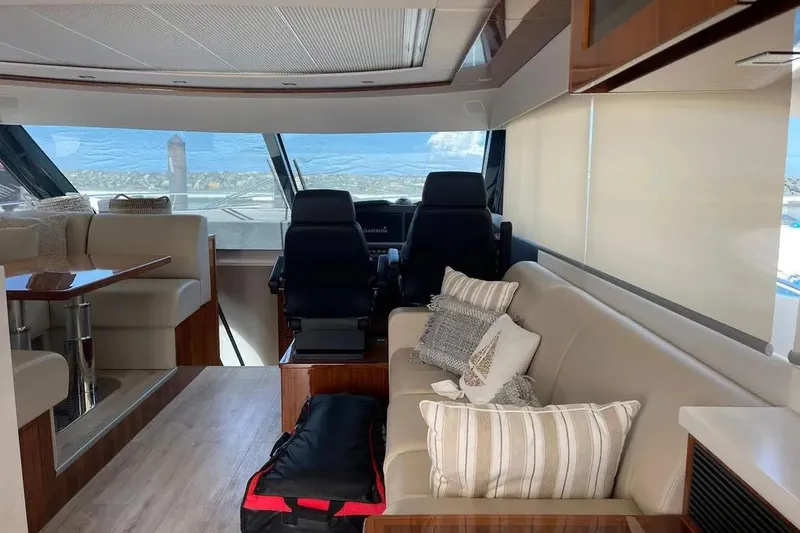  Yacht Photos Pics Luxurious interior of 2020 Riviera 6000 Motor Yacht with plush seating and panoramic windows.