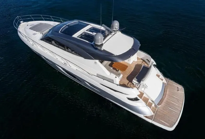  Yacht Photos Pics 2020 Riviera 6000 Motor Yacht cruising on open water, aerial view.
